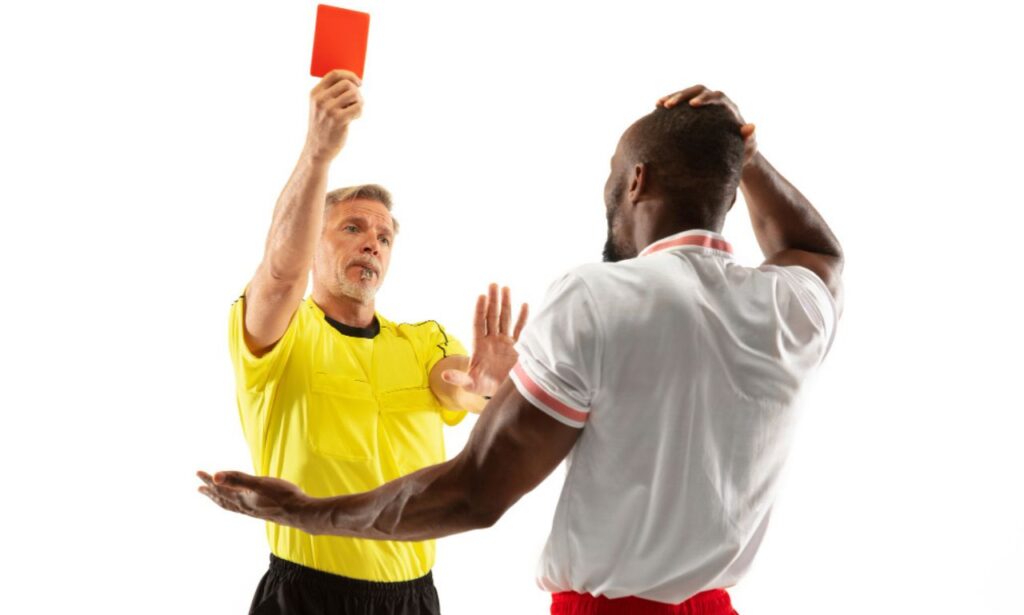 A football player getting red card from empire