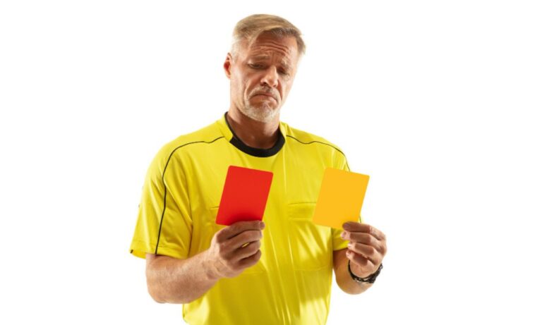 Yellow and Red Card in hands of football empire